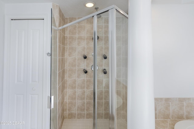 bathroom featuring a shower with shower door