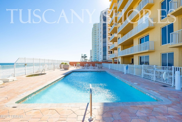 view of pool with a water view