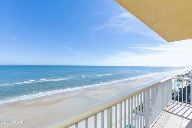 balcony with a beach view and a water view