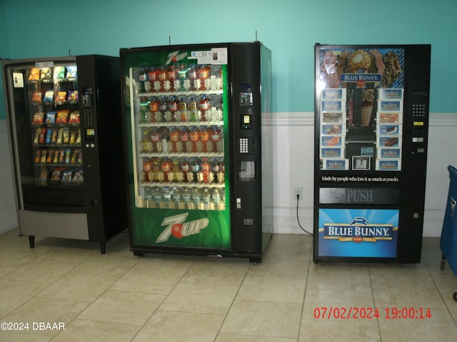 bar featuring black refrigerator with ice dispenser and tile patterned floors