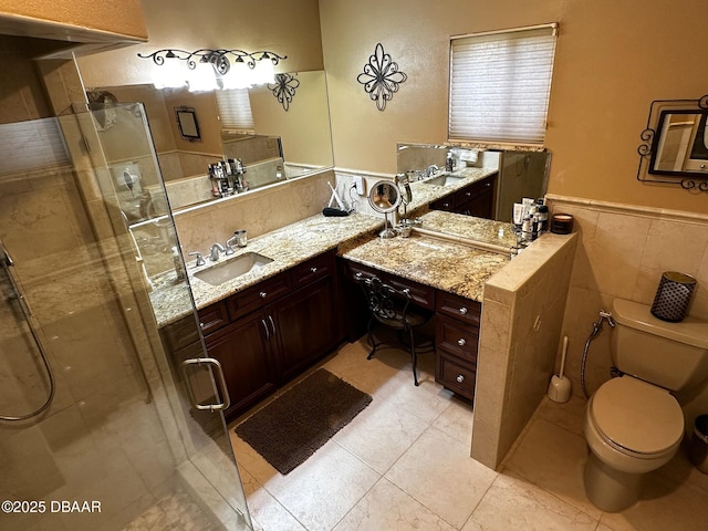 bathroom featuring tile walls, vanity, walk in shower, toilet, and tile patterned floors