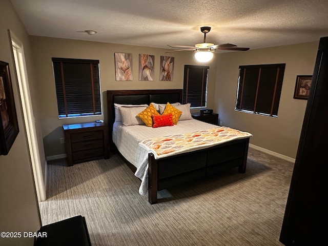 carpeted bedroom featuring ceiling fan and a textured ceiling