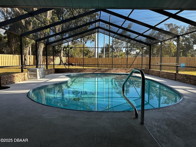 view of pool featuring a patio and glass enclosure