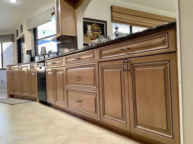 kitchen featuring light tile patterned floors and dark stone counters