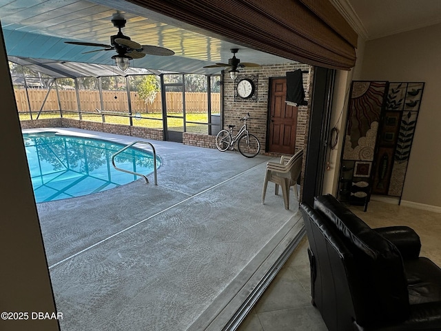 view of pool with ceiling fan, a lanai, and a patio area