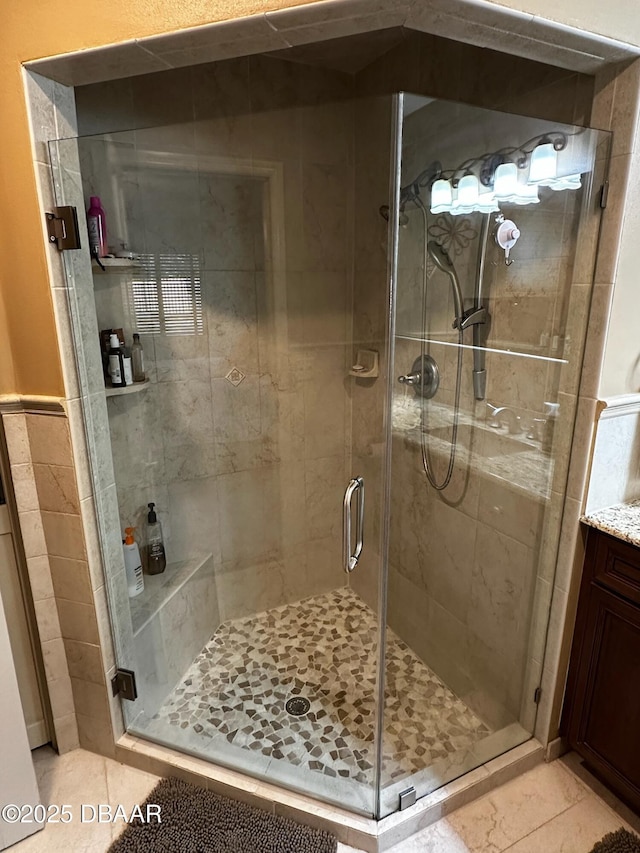 bathroom featuring an enclosed shower and vanity