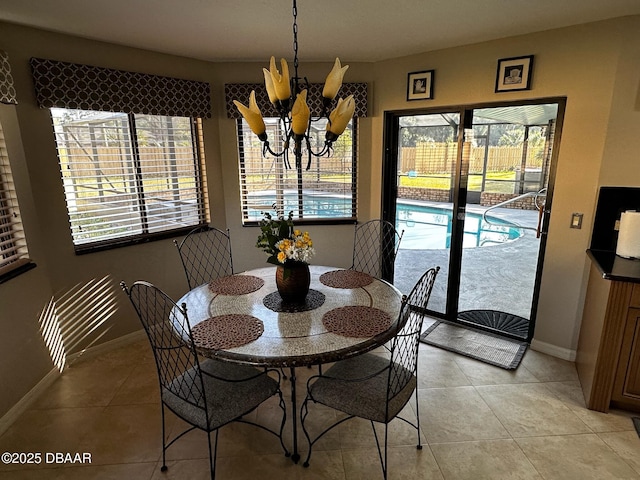 dining space featuring light tile patterned floors and an inviting chandelier