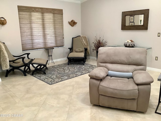 sitting room with ornamental molding and light tile patterned floors