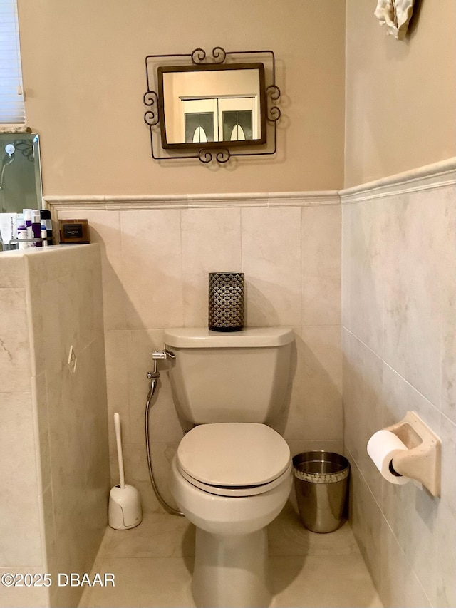 bathroom featuring tile walls, tile patterned flooring, and toilet