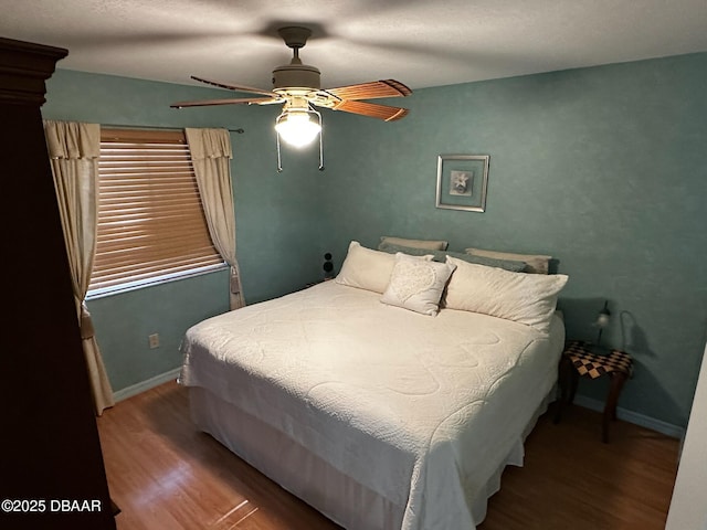 bedroom with wood-type flooring and ceiling fan