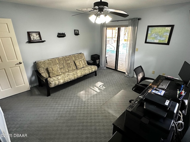 carpeted office space featuring ceiling fan