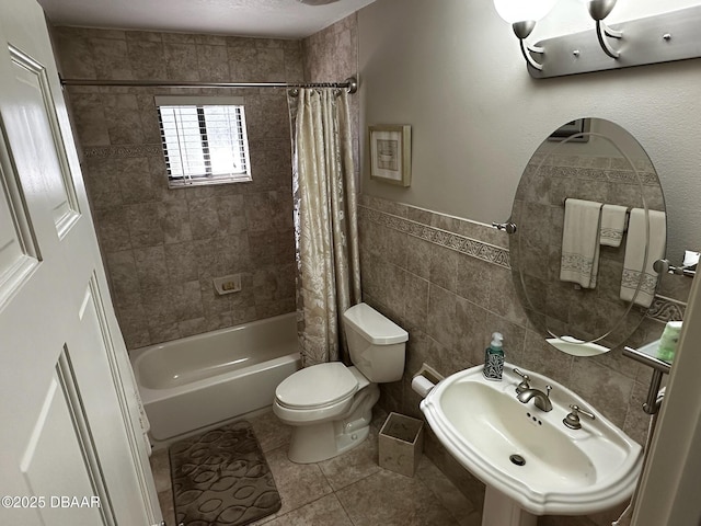 full bathroom with shower / bathtub combination with curtain, sink, tile walls, tile patterned floors, and toilet