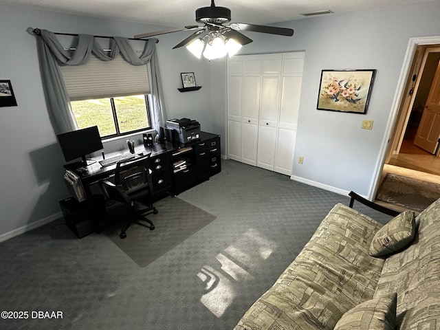 carpeted office space featuring ceiling fan