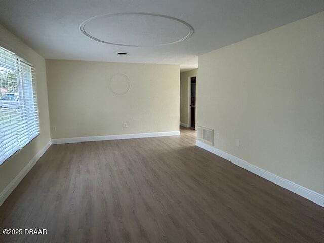 spare room featuring dark hardwood / wood-style floors