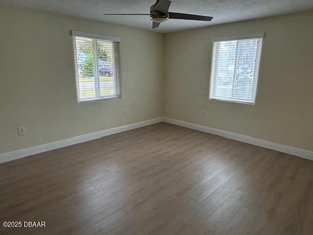 spare room with ceiling fan and wood-type flooring