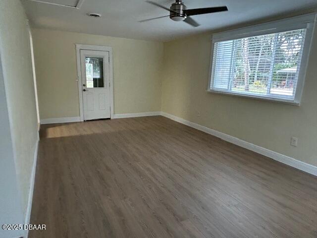 empty room with ceiling fan and hardwood / wood-style floors