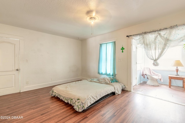 bedroom with wood-type flooring and ceiling fan