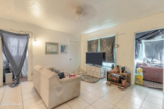 tiled living room featuring ceiling fan and plenty of natural light