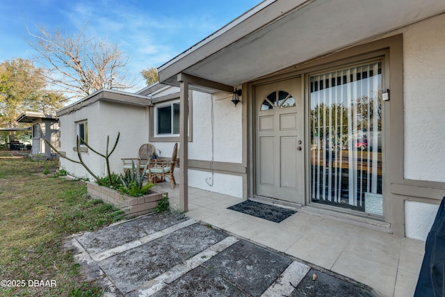 property entrance featuring a patio area