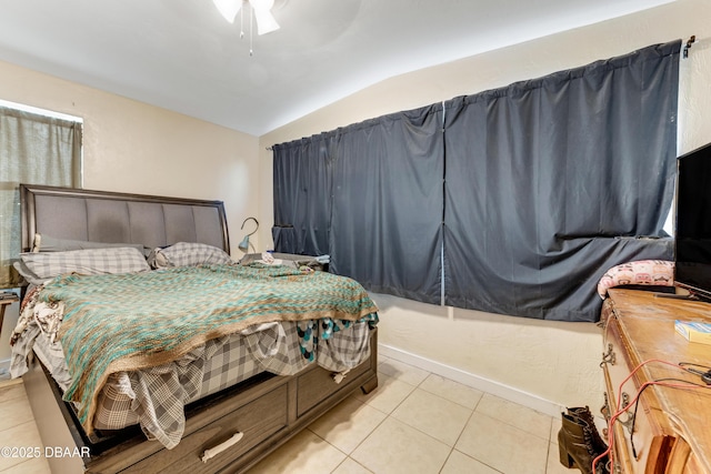 tiled bedroom featuring ceiling fan and lofted ceiling