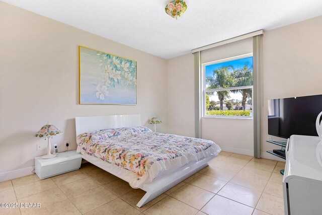1248 Girog Ave, Port Orange, FL 32129 - bedroom with light tile patterned floors and baseboards