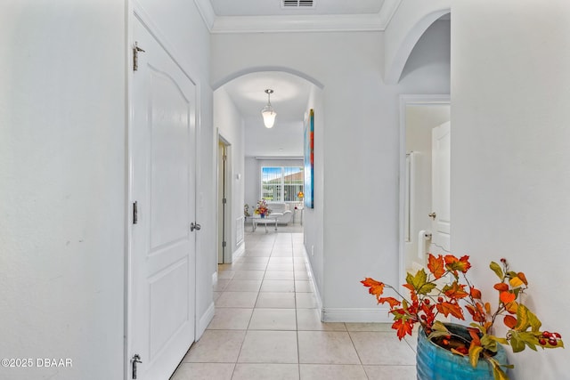 1248 Girog Ave, Port Orange, FL 32129 - hallway featuring arched walkways, light tile patterned floors, baseboards, and ornamental molding