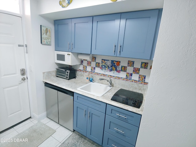 kitchen with blue cabinets, light tile patterned flooring, sink, and stainless steel dishwasher