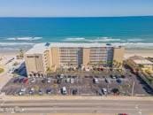 bird's eye view featuring a view of the beach and a water view