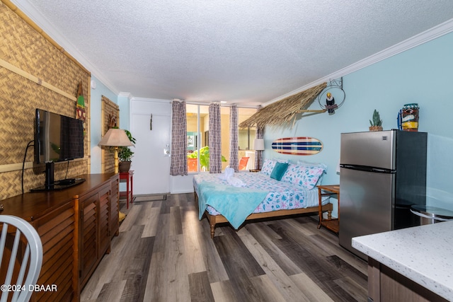 2043 S Atlantic Ave Unit 105, Daytona Beach, FL 32118 - bedroom with freestanding refrigerator, a textured ceiling, crown molding, and dark wood-style flooring