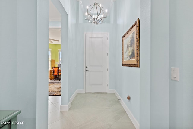 tiled foyer featuring a notable chandelier