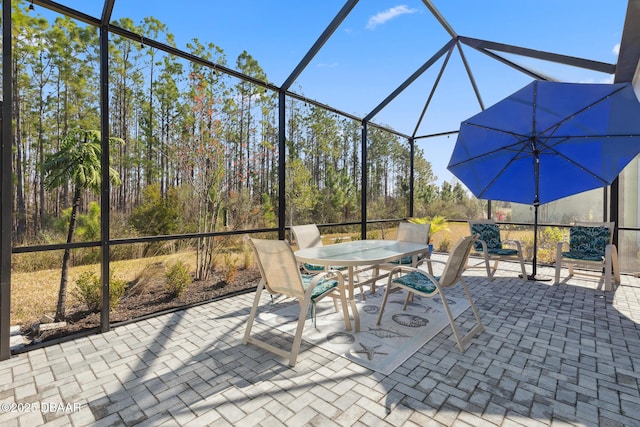 view of patio / terrace featuring glass enclosure