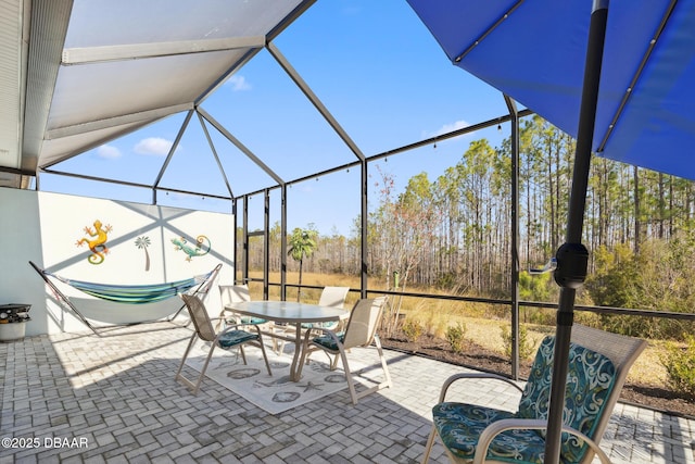 view of patio featuring a lanai