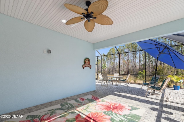 view of patio / terrace with ceiling fan and glass enclosure