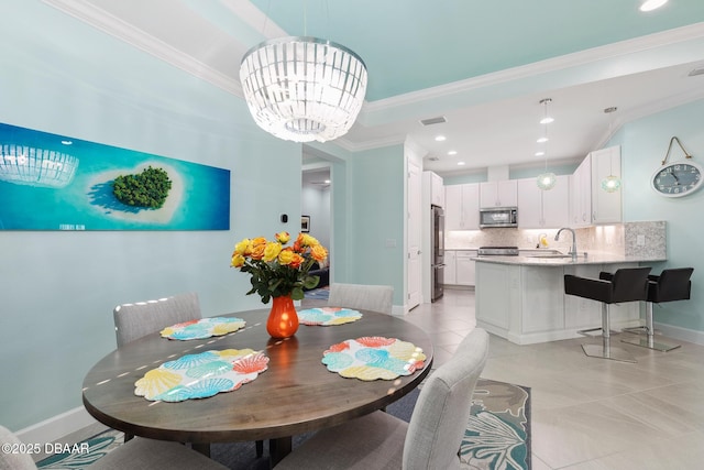 dining area with an inviting chandelier, sink, crown molding, and light tile patterned floors