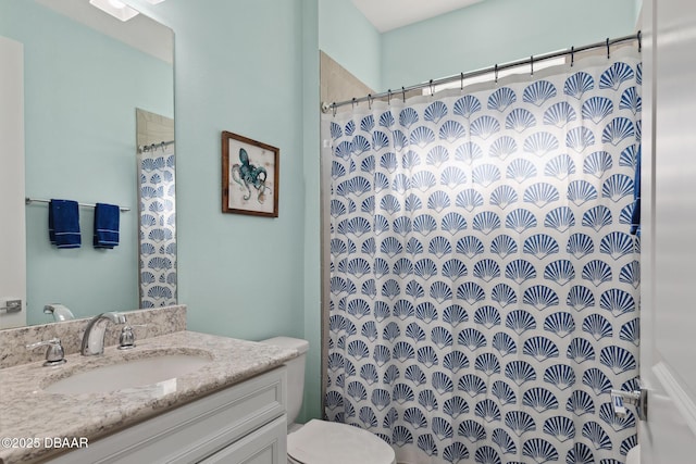 bathroom featuring vanity, curtained shower, and toilet