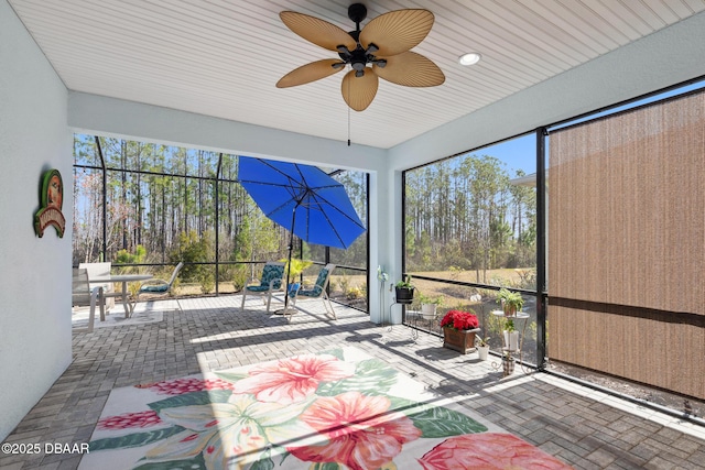 sunroom featuring plenty of natural light and ceiling fan