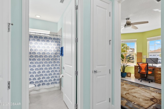 bathroom with shower / bath combo, ceiling fan, and toilet