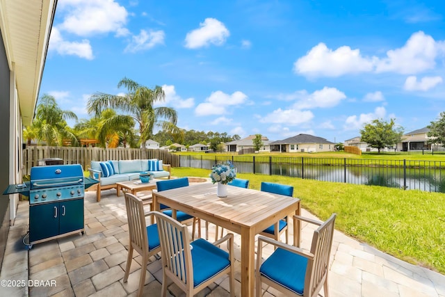 view of patio / terrace with an outdoor living space, outdoor dining area, a residential view, a fenced backyard, and a water view