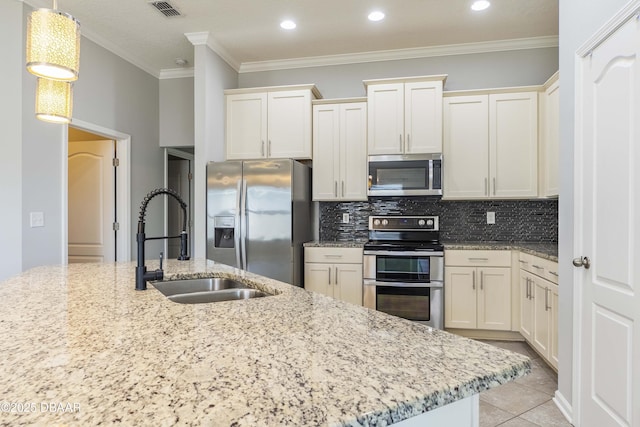 kitchen with backsplash, visible vents, crown molding, appliances with stainless steel finishes, and light stone countertops