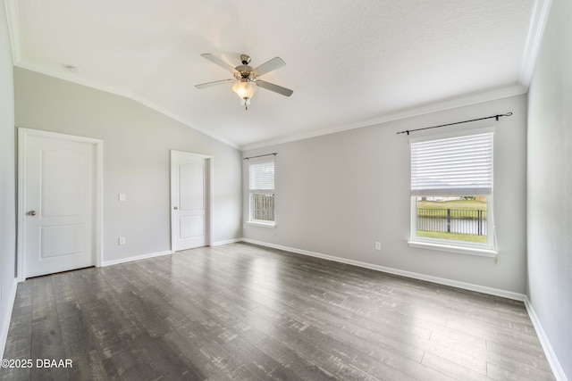 unfurnished room featuring crown molding, baseboards, ceiling fan, dark wood-type flooring, and vaulted ceiling