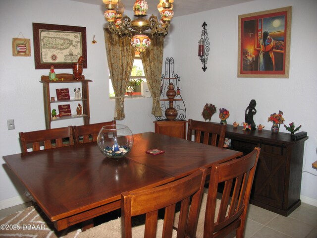 39 Benjamin Dr, Ormond Beach, FL 32176 - dining area featuring a chandelier, baseboards, and tile patterned flooring