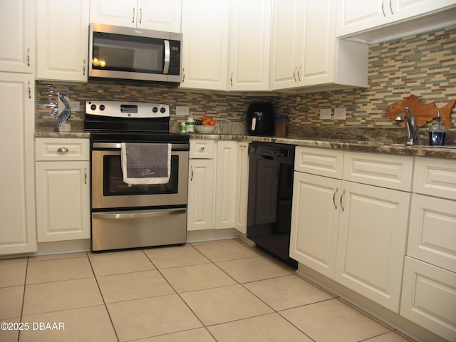 39 Benjamin Dr, Ormond Beach, FL 32176 - kitchen featuring appliances with stainless steel finishes, white cabinets, light tile patterned floors, and decorative backsplash