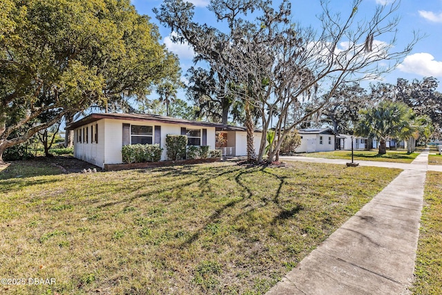 ranch-style home featuring a front yard