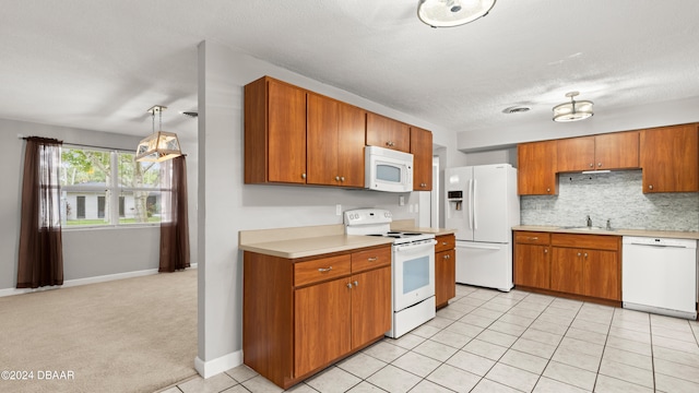 kitchen featuring sink, tasteful backsplash, a textured ceiling, light tile patterned floors, and white appliances