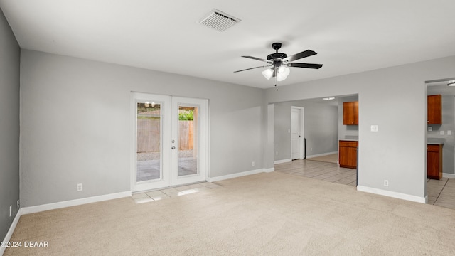 spare room featuring light carpet and ceiling fan