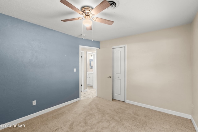 unfurnished room with ceiling fan and light colored carpet