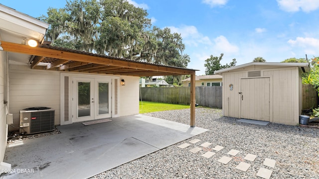 view of patio with a storage unit, cooling unit, and french doors