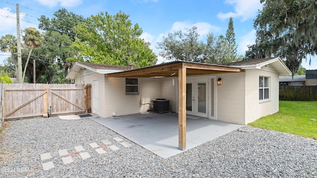 back of house featuring a patio, central AC, and french doors