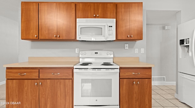 kitchen featuring white appliances and light tile patterned floors