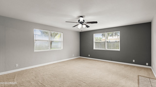 unfurnished room featuring light colored carpet and ceiling fan